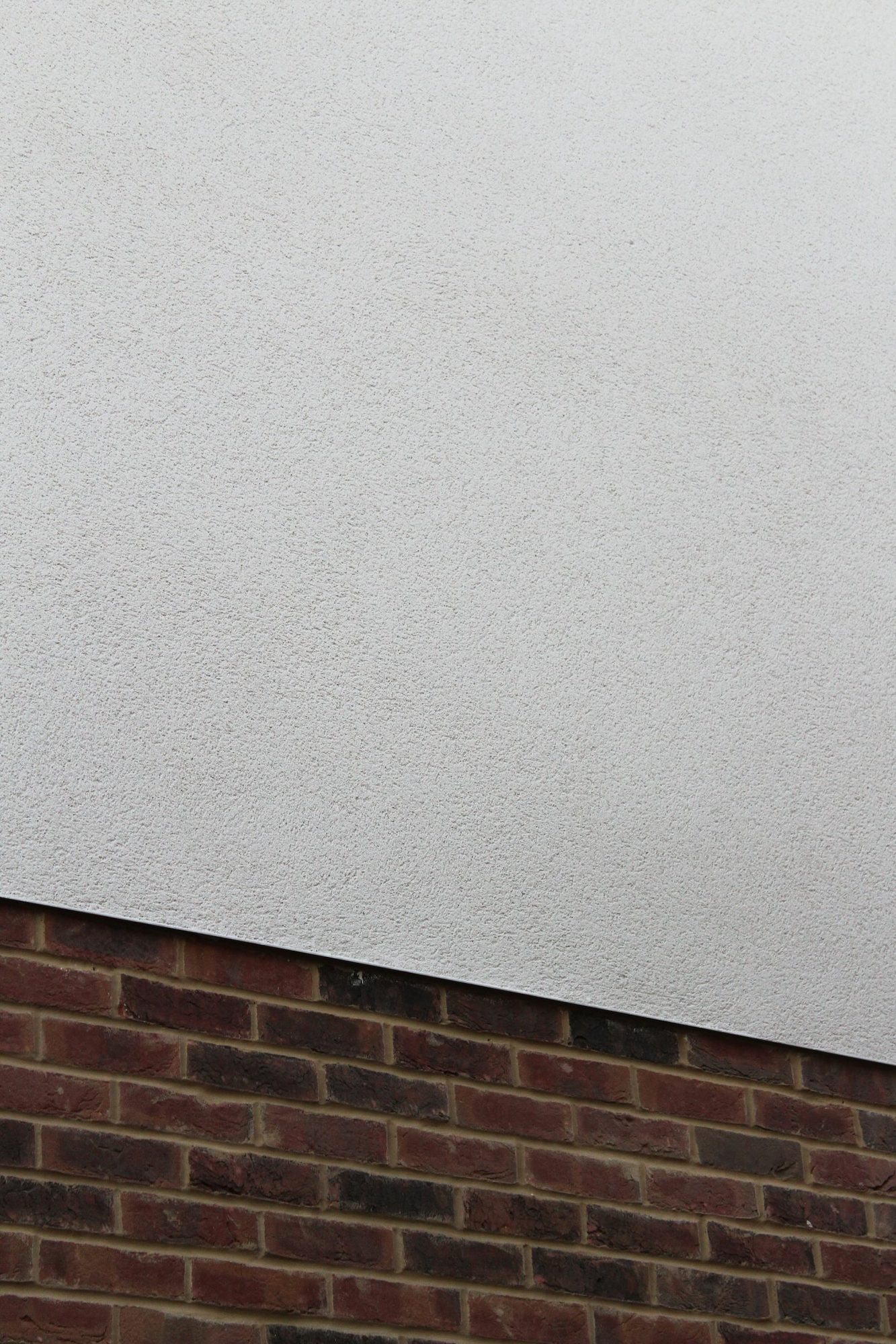 Texture coating on exterior facade — polymer-modified rendered finish by Limekote, Sunshine Coast commercial and residential